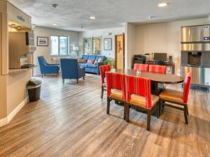 a dining room and living room with a table and chairs at Yellowstone River Inn & Suites in Livingston