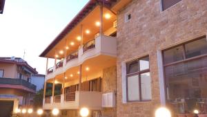 a building with lights on the side of it at House Chrysoula Mitsokopi in Sarti
