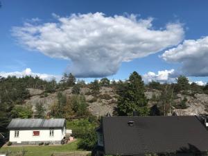 a house with a mountain in the background at Fagerbacka Torp. Söt stuga nära havet in Lysekil +5 photos