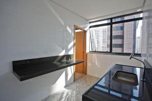 a bathroom with a glass counter and a window at Locking's Lourdes 10 in Belo Horizonte