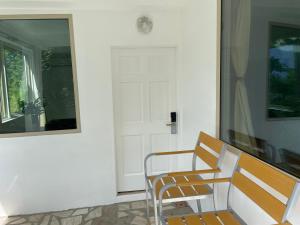 a table and two chairs in front of a door at Green Fig Resort & Spa in Soufrière