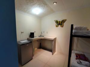 a room with a desk with a butterfly on the wall at Hospedaje La Galerie in Ciudad Cortés