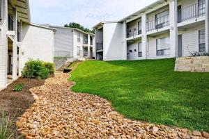 a walkway in front of some apartment buildings at SoCo Chic Apartment Suites Close to Downtown in Austin