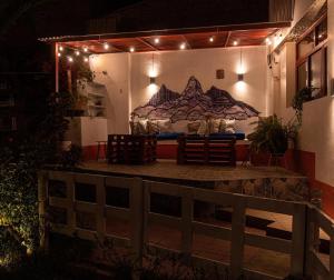 a room with a bed on a wall with lights at Jo´s Place in Huaraz