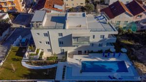 an aerial view of a house with a swimming pool at R&R Residence Podstrana in Podstrana