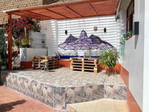 a patio with a bed on the side of a building at Jo´s Place in Huaraz