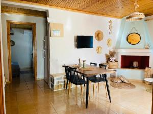 a dining room with a table and a fireplace at Dream house Villa in Alyki