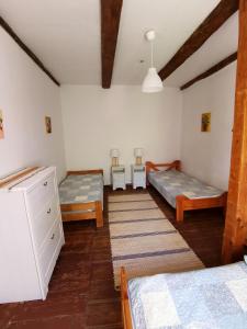 a room with two beds and two tables in it at Leszczynowy Sad - apartament z kominkiem i ogrodem in Wydminy