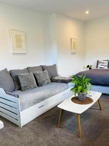 a living room with a couch and a bed at The White Room in Wanaka
