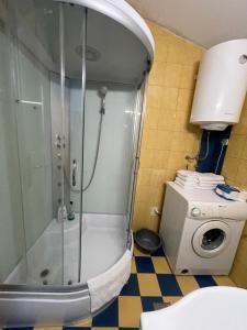 a shower in a bathroom with a washing machine at House with big terrace and beautiful sea view in Kotor