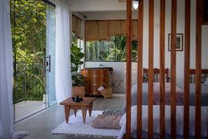 a bedroom with a bed and a sliding glass door at Segunda Casa in Paraty