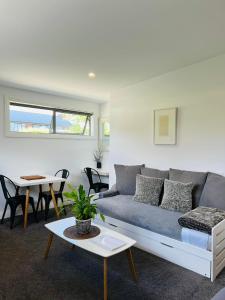 a living room with a couch and a table at The White Room in Wanaka