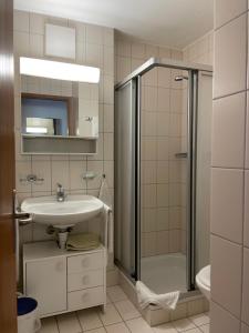 un bagno con lavandino e doccia di Gasthaus Beverin a Fardün