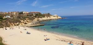 a group of people on a beach near the water at SUITE GUEST HOUSE a pochi minuti dal Mare in Sassari