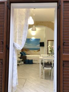 an open door to a living room with a table at A Petrazzi in Castellammare del Golfo +10 photos