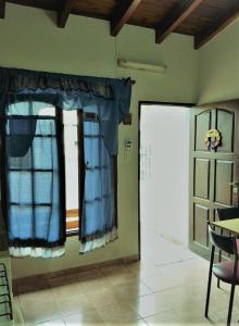 a room with blue curtains and a window at EL AURA in Federación