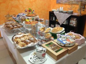 a buffet of pastries and other food on a table at Le Sirene Bed and Breakfast in Cellamare