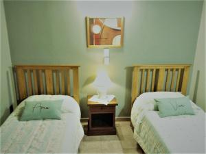 two beds sitting next to each other in a room at EL AURA in Federación