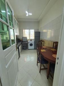 a kitchen with a table and a dining room at Residence Bouanane B in Fez