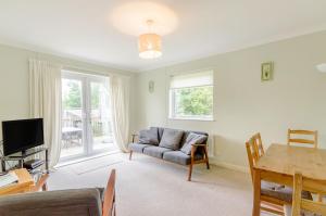 a living room with a couch and a table at Beefs Park Farm Annexe in Carmarthen