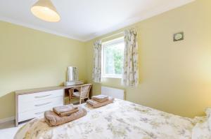 a bedroom with a large bed with towels on it at Beefs Park Farm Annexe in Carmarthen