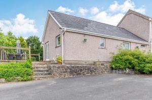 a house with a stone driveway in front of it at Beefs Park Farm Annexe in Carmarthen