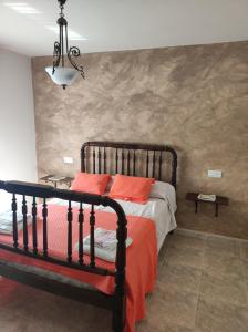 Un dormitorio con una cama con almohadas rojas. en Entrecastaños, en Rozas