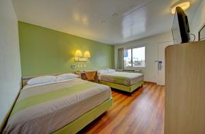 A bed or beds in a room at Motel 6-Cocoa Beach, FL