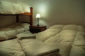 Una cama o camas en una habitación de Cabañas Valles Calchaquíes