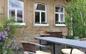a table and chairs in front of a building with windows at 3 Bedroom Nice Home In Zeil Am Main in Zeil