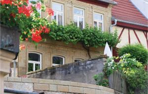 a house with a retaining wall with flowers on it at 3 Bedroom Nice Home In Zeil Am Main in Zeil +18 photos