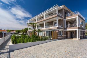 a white apartment building with a balcony at Villa Velvet in Villeneuve-Loubet