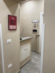 a waiting room with a sign that reads thank you for not smoking at Valentine’s house in Naples