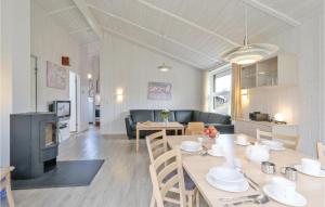 a kitchen and living room with a table and chairs at Abendrot 6 - Dorf 3 in Priwall +20 photos