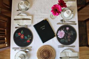 a table with plates and utensils on it at Dun Ri Guesthouse in Clifden