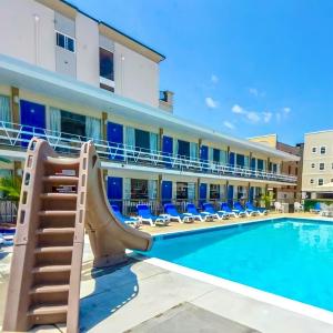 a resort with a slide and a swimming pool at Beach Colony Motel in Wildwood Crest