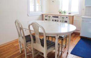 a white table and chairs in a kitchen at 3 Bedroom Lovely Home In Dalum in Tomten