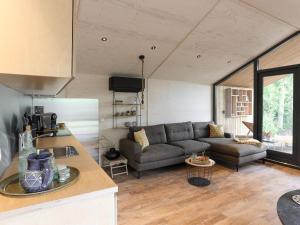 a living room with a couch and a table at Welcoming holiday home in Wissenkerke with private sauna in Wissenkerke