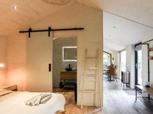 a room with a bed and a wooden ladder at Welcoming holiday home in Wissenkerke with private sauna in Wissenkerke