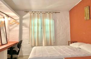เตียงในห้องที่ Waimea Flats Maresias
