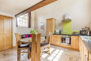 a kitchen and dining room with a table and chairs at The Old Chapel in Goxhill