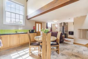 a kitchen and dining room with a table and chairs at The Old Chapel in Goxhill