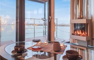 a dining room with a glass table and a fireplace at Mermaid-hausboote 1 in Lelystad