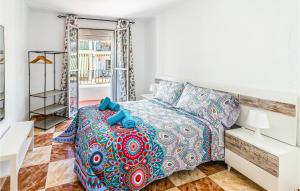 a bedroom with a large bed with blue pillows at Gorgeous Apartment In Cordoba With Wifi in Córdoba