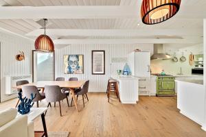 a kitchen and dining room with a table and chairs at Big Rock Seaside Beach House in Malibu