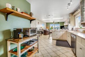 a large kitchen with green walls and wooden cabinets at Bay Watch North in Birch Bay