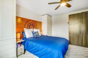 a bedroom with a blue bed and a ceiling fan at Bay Watch North in Birch Bay