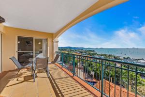a balcony with a view of the ocean at Magnificence At Airlie in Airlie Beach