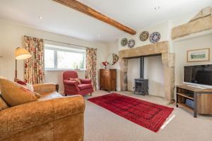 a living room with a couch and a fireplace at Bumble Cottage in Darley