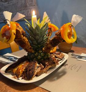 a plate of food with a pineapple centerpiece on a table at Poseidon Hotel in Hirschhorn